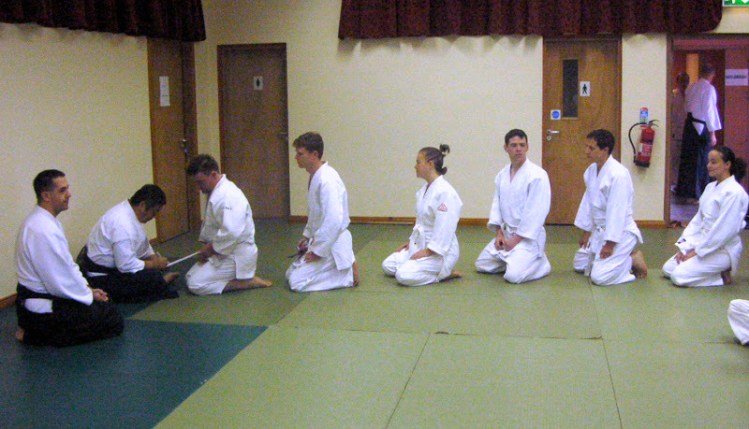 Tony assists Gaku Homma during the belt signing session